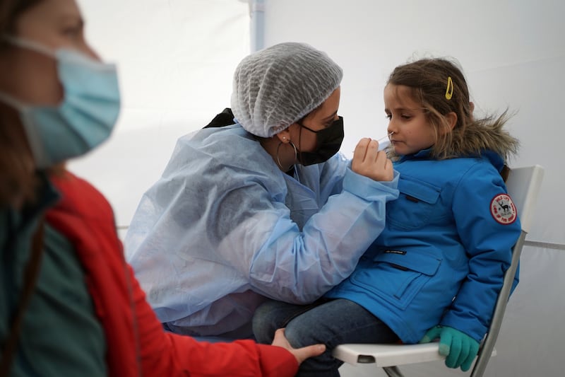Suzanne, 5, is tested for Covid-19 in Albigny-sur-Saone, outside Lyon in central France. AP