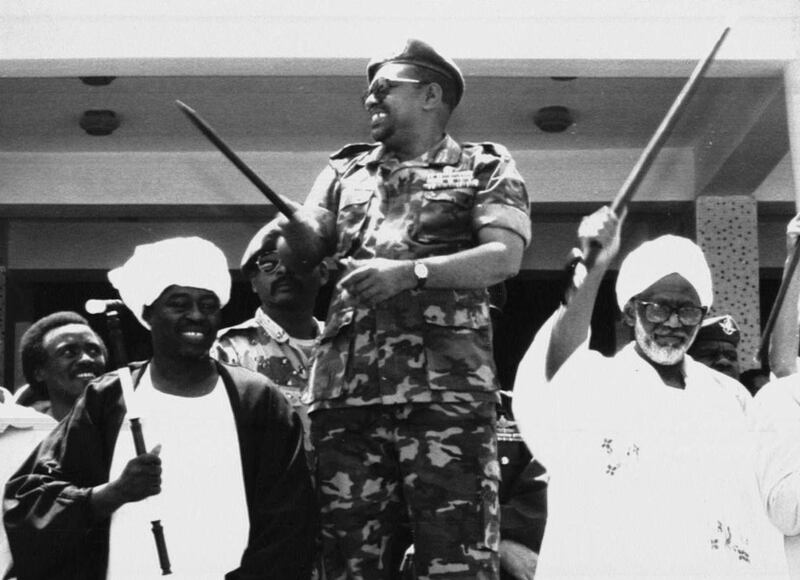 Al Bashir is flanked by Sudanese cleric Hassan Turabi, left, and by Mohamed El Amin Khalifa,  Sudan’s parliamentary speaker, during a rally in support of Al Bashir’s regime and anger at Egypt in Khartoum, on Monday July 3, 1995.