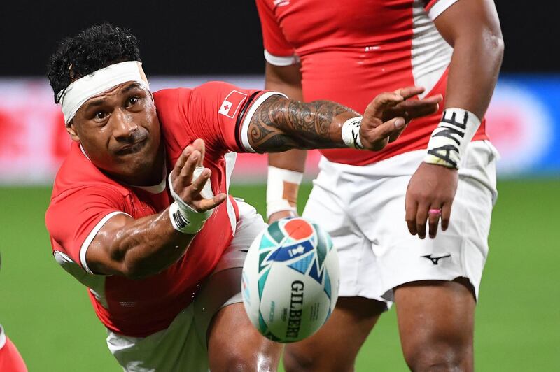Tonga scrum-half Sonatane Takulua passes the ball during the match against England at the Sapporo Dome. AFP