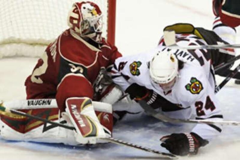 The Chicago Blackhawks' Martin Havlat falls into the Minnesota Wild goaltender Niklas Backstrom during Sunday night's game. Chicago went on to win the contest 4-1 to set a new franchise record for successive wins as they registered their ninth victory in a row.
