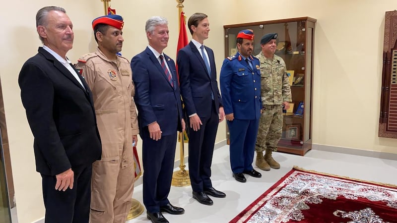 Senior White House adviser Jared Kushner, centre right, and the US National Security Adviser Robert O'Brien, centre left, pose for a photo with UAE Air Force's Maj Gen Falah Al Qahtani,, and other officials at Al Dhafra airbase in Abu Dhabi. Reuters