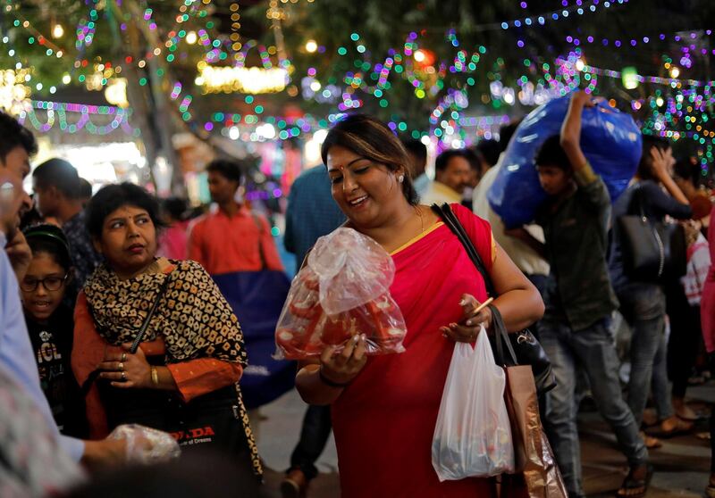 A woman buys lamps in a market on the eve of Diwali. Reuters