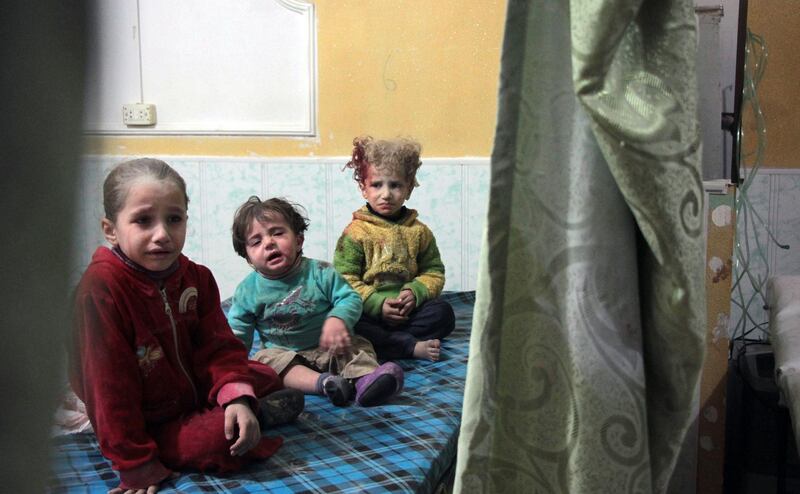 Syrian children sit at a makeshift clinic following reported shelling by Syrian government forces, in the rebel-held town of Douma in Syria's eastern Ghouta region, on November 17, 2017.
Shelling by the Syrian regime on the rebel-held Eastern Ghouta, which has been besieged since 2013 and where humanitarian conditions are dire, killed at least 10 civilians, among them six children, the Syrian Observatory for Human Rights said.
The deaths were the result of the latest bout in an escalating cycle of tit-for-tat attacks between regime forces and the rebels holding the enclave on the Syrian capital's eastern outskirts. / AFP PHOTO / Hamza Al-Ajweh