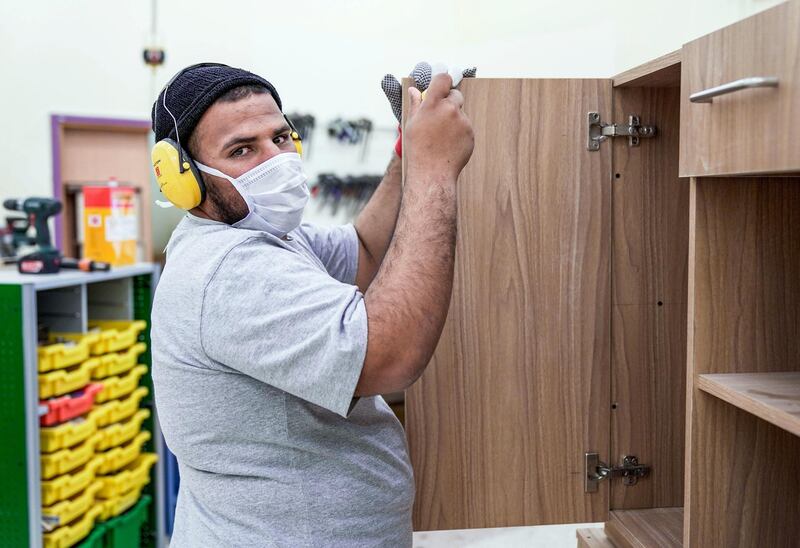 Abu Dhabi, United Arab Emirates, February 13, 2020.  
   Story Brief:  A story on the carpentry workshop at Zayed High Organisation for people of determination, where people with special needs aremaking tables and podiums that are used in government buildings and mosques. 

-- Saleh Thahed assembling a wooden cabinet at the workshop.

Victor Besa / The National
Section:  NA
Reporter:  Haneen Dajani