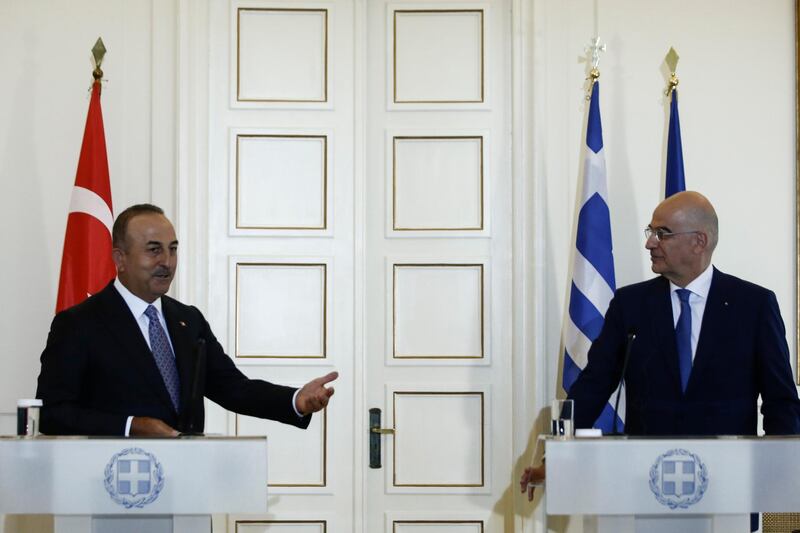 epa09238686 Turkish Foreign Minister Mevlut Cavusoglu (L) talks next to Greek Foreign Minister Nikos Dendias (R) during joint statements after their meeting, in Athens, Greece, 31 May 2021. Cavusoglu is in Athens on a working visit.  EPA/YANNIS KOLESIDIS