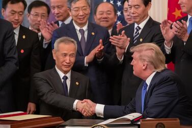 US President Donald Trump and Chinese Vice Premier Liu He participate in a signing ceremony in the East Room of the White Houseon Wednesday. EPA
