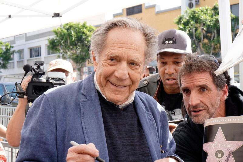 epa09092671 (FILE) - US actor George Segal poses with fans on the Hollywood Walk of Fame during the Hollywood Walk of Fame Star ceremony in Hollywood, California, USA, 14 February 2017 (reissued 24 March 2021). Oscar-nominated actor George Segal died on 23 March 2021 due to complications from heart bypass surgery. He was 87.  EPA/NINA PROMMER