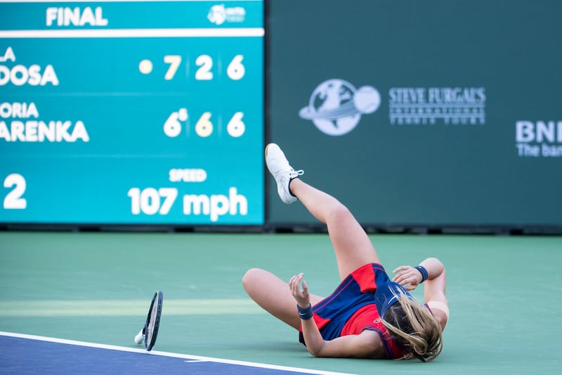Paula Badosa drops to the ground after defeating Victoria Azarenka. AP Photo