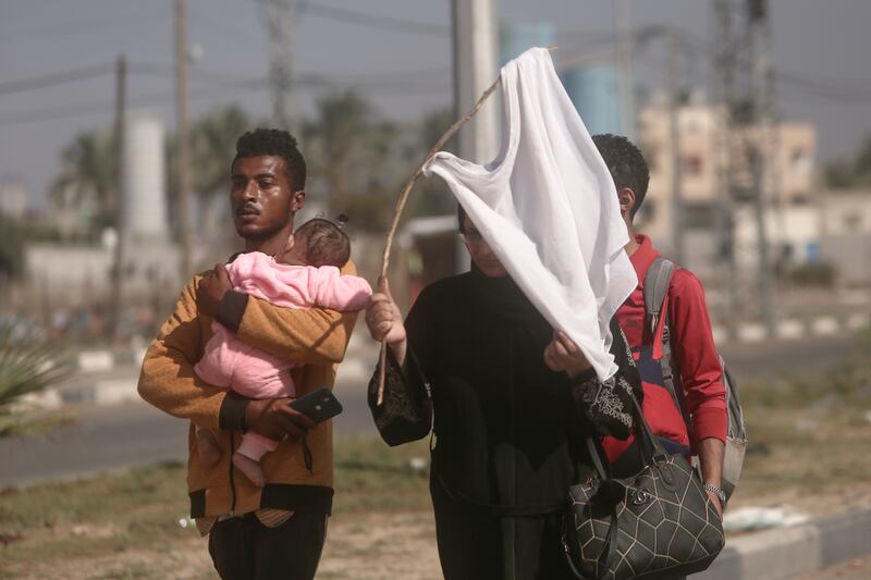 Palestinians flee Gaza city to the southern Gaza Strip on Salah al-Din street in Bureij. AP