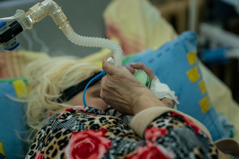 A patient with coronavirus breathes with the help of an oxygen mask at an intensive care unit in the regional hospital in Chernivtsi, western Ukraine. AP Photo
