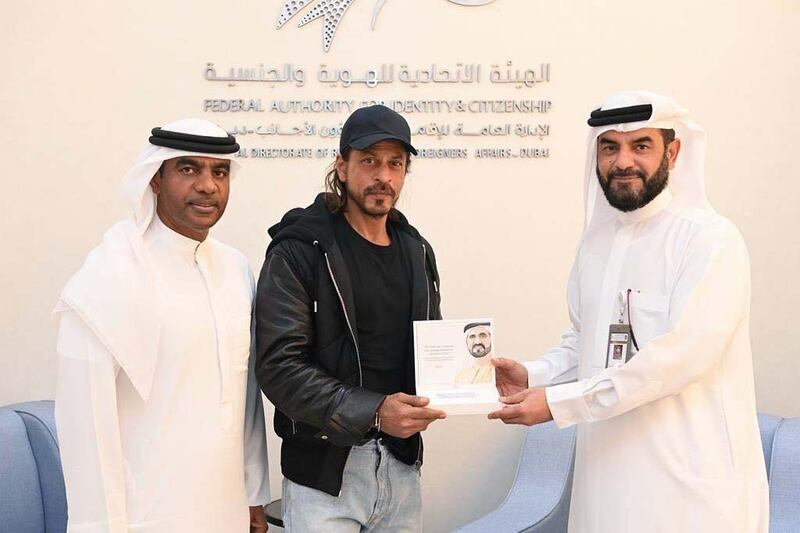 Dubai's General Directorate of Residency and Foreigners Affairs officials present Bollywood star Shah Rukh Khan with the Happiness Card. Photo: GDRFA Dubai