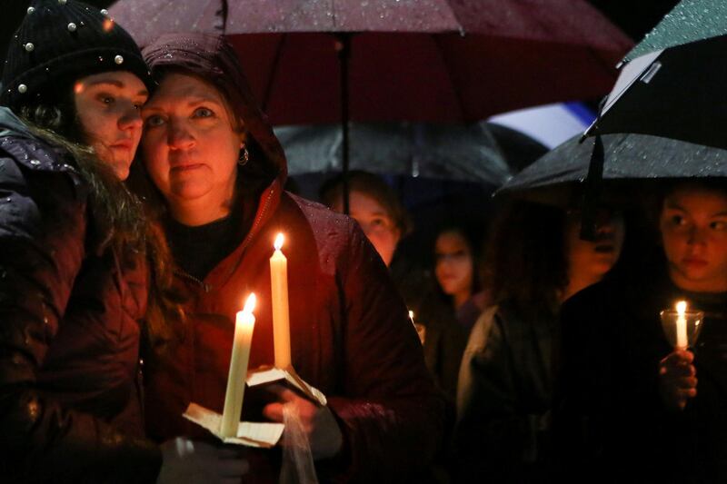 Lizzie and Kathy Varda take part in a vigil led by the Junior Newtown Action Alliance to mourn students and teachers lost in a mass shooting in Florida's Stoneman Douglas High School. Michelle McLoughlin / Reuters