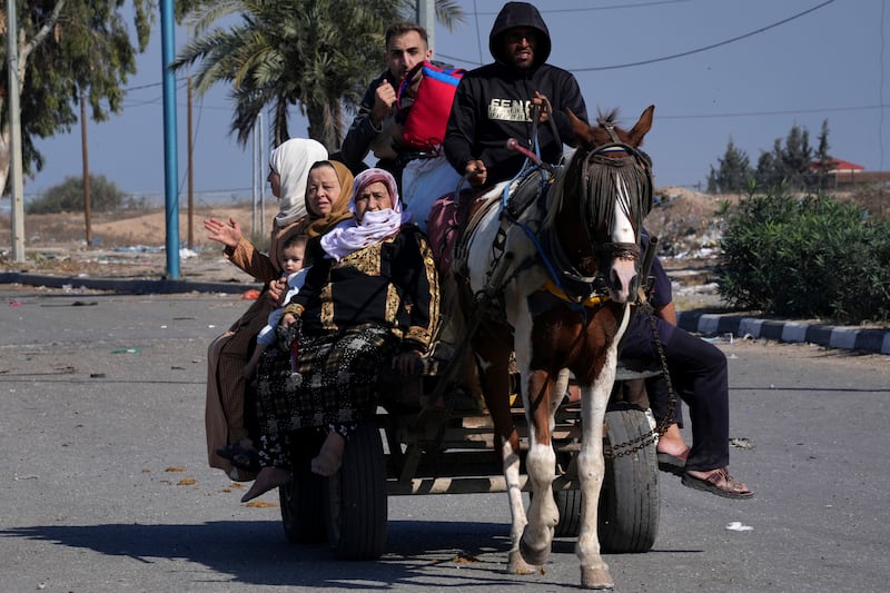 Palestinians flee to the southern Gaza Strip along Salah al-Din Street, during the ongoing Israeli bombardment. AP