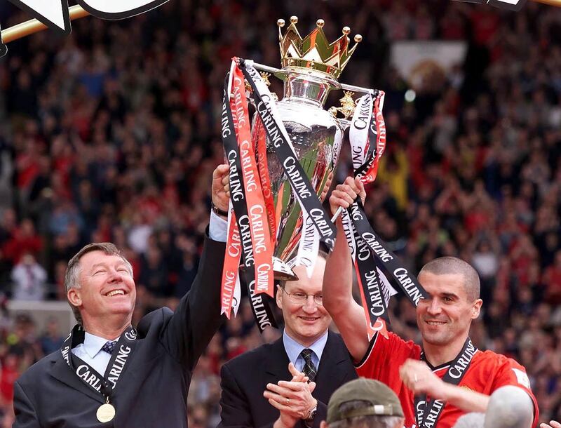 Manchester United manager Sir Alex Ferguson lifts the Premiership trophy with his captain Roy Keane in 2001. PA