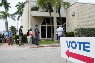 People wait in line to vote outside of an early voting site in Miami Beach, Florida. AP