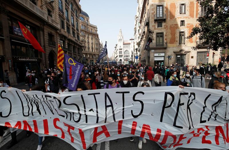 Demonstrators in Barcelona hold a banner during a protest in support of Catalan rapper Pablo Hasel, after he was given a jail sentence on charges of glorifying terrorism and insulting royalty in his songs,. Reuters