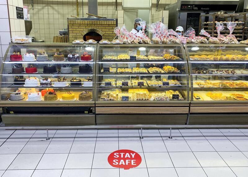 DUBAI, UNITED ARAB EMIRATES. 6 JULY 2020. 
“We Care” sign by the bakery section at Union Coop in Al Barsha Mall. The sign invites people to maintain social distancing.
(Photo: Reem Mohammed/The National)

Reporter:
Section: