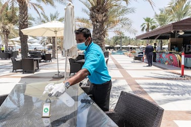 RAS AL KHAIMAH, UNITED ARAB EMIRATES. 21 MAY 2020. A tour with RAK Tourism Development Authority inspectors to know more about Hilton Ras Al Khaimah Resort & Spa’s preventive and hygiene measures as they open up after the hotel lockdown. A table at the beach restaurant is sanitized after each guests to prevent the possible spread of COVID-19. (Photo: Antonie Robertson/The National) Journalist: Ruba Haza. Section: National.