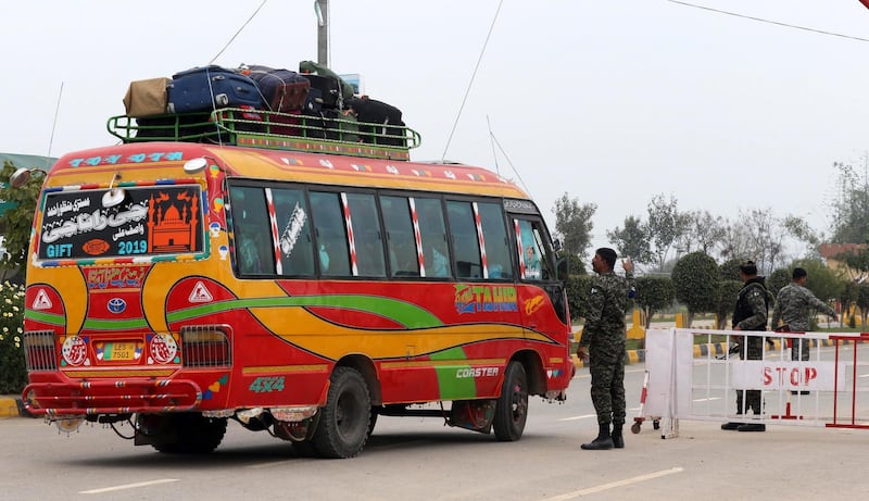 A Pakistani security official checks a bus carrying passengers to India, as Pakistan is set to free Indian fighter pilot Abhinandan Varthaman, at Pakistan-India joint border Wagah, near Lahore, Pakistan, 01 March 2019. According to media reports, Pakistan is set to hand over IAF Wing Commander Abhinandan as a 'peace gesture' to India after he was taken into custody by the Pakistan forces after his jet was downed in Pakistan territory.  EPA