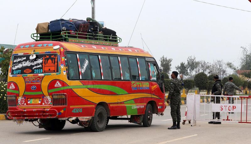 A Pakistani security official checks a bus carrying passengers to India, as Pakistan is set to free Indian fighter pilot Abhinandan Varthaman, at Pakistan-India joint border Wagah, near Lahore, Pakistan, 01 March 2019. According to media reports, Pakistan is set to hand over IAF Wing Commander Abhinandan as a 'peace gesture' to India after he was taken into custody by the Pakistan forces after his jet was downed in Pakistan territory.  EPA