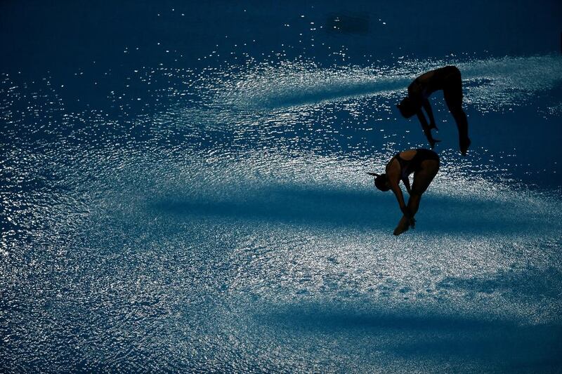 Jennifer Abel and Pamela Ware of Canada dive in the  during the Fina Diving World Series 2014 at the Hamdan Sports Complex in Dubai. Warren Little / Getty Images 