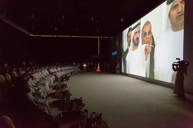 Attendees of the Meydan One launch watch a video featuring Sheikh Mohammed Bin Rashid. Duncan Chard for the National.