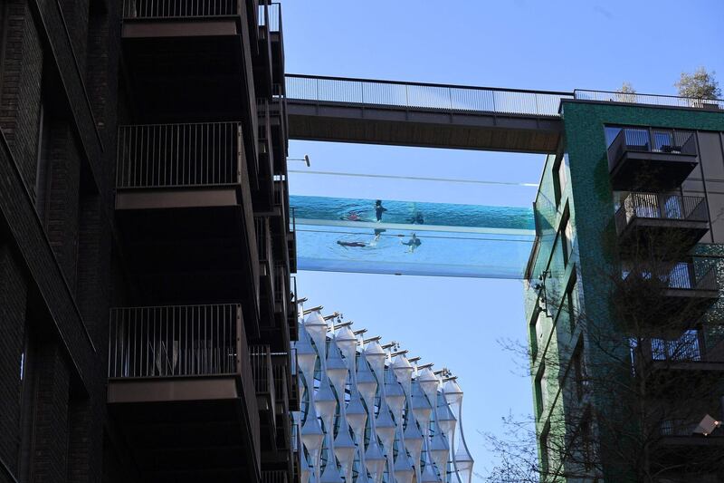 Swimmers on the Sky Pool, a transparent swimming pool bridge that spans between two residential blocks in the Nine Elms area of London, on Friday, April 23. AP