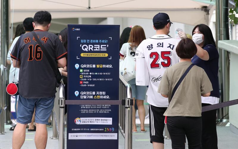 Fans enter the Jamsil Baseball Stadium in Seoul. EPA