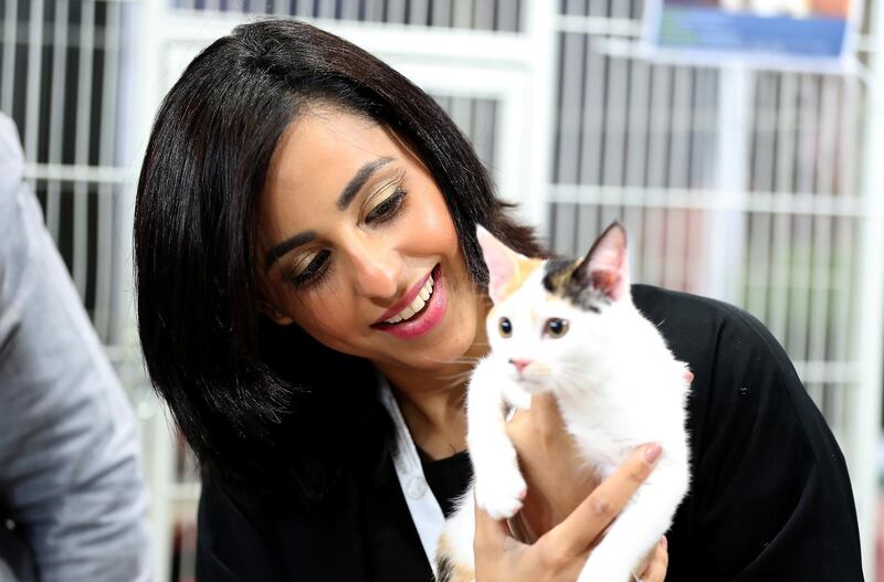 ABU DHABI ,  UNITED ARAB EMIRATES , AUGUST 28 – 2019 :- Afra Al Dhaheri , owner holding the cat at the Cloud 9 Pet Hotel & Care stand during the ADIHEX 2019 held at ADNEC in Abu Dhabi. ( Pawan Singh / The National ) For News.. Story by Daniel 