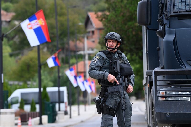 An armed Kosovo Police officer patrols the village of Banjska. EPA