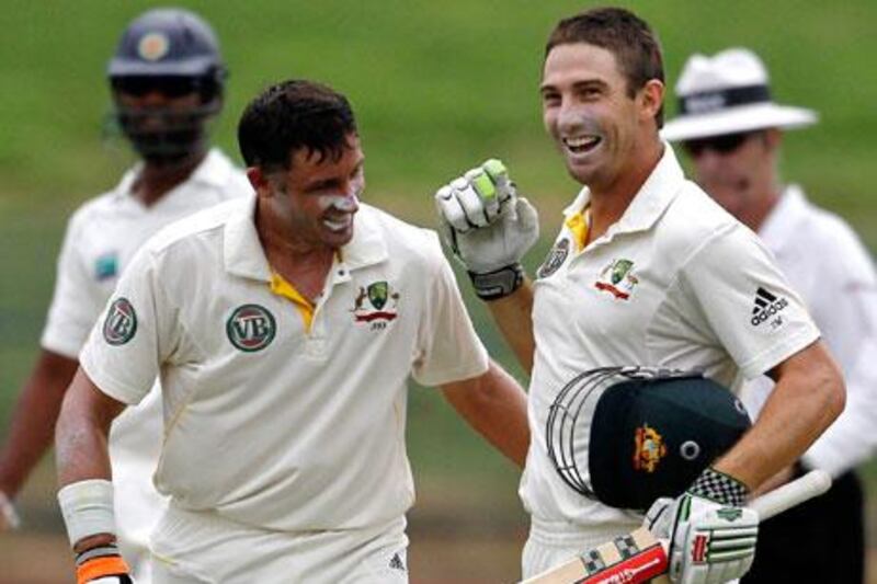 Australian batsman Shaun Marsh, right, and is congratulated by Michael Hussey after Marsh scored a century during the third day of the second cricket test match between Sri Lanka and Australia in Pallekele, Sri Lanka.
