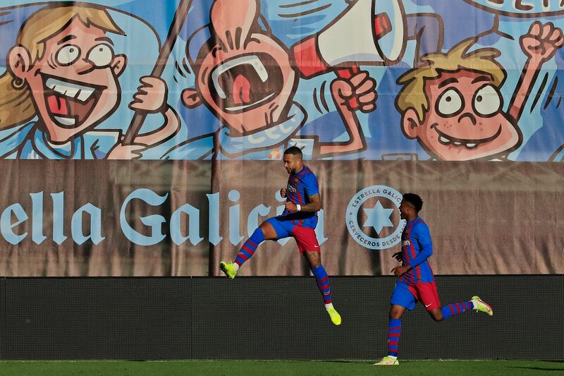 Barcelona's Memphis Depay, left, celebrates after scoring his side's third goal. AP
