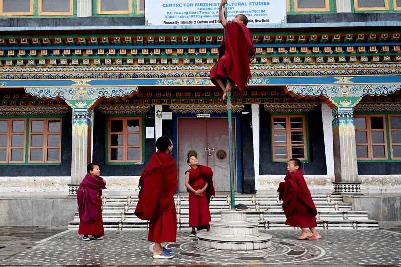Young Buddhist monks play between prayers at the Tawang monastery in Tawang town in the north-east Indian state of Arunachal Pradesh. AFP