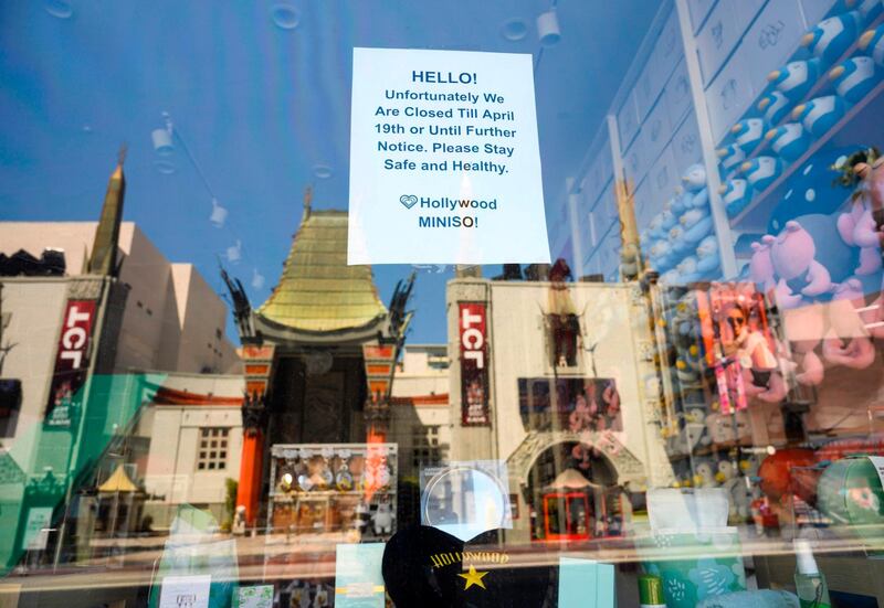 The TCL Chinese Theatre is reflected in the window of the closed variety store Minsio in Hollywood, California during the coronavirus pandemic. Movie theatres and the entertainment world in general is expected to experience massive losses because the pandemic. AFP