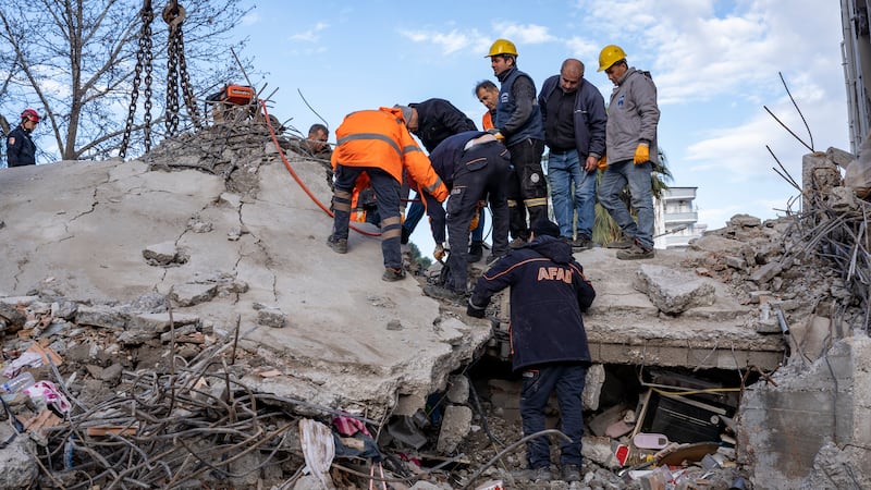 Rescuers carefully work through the rubble in hopes of finding survivors