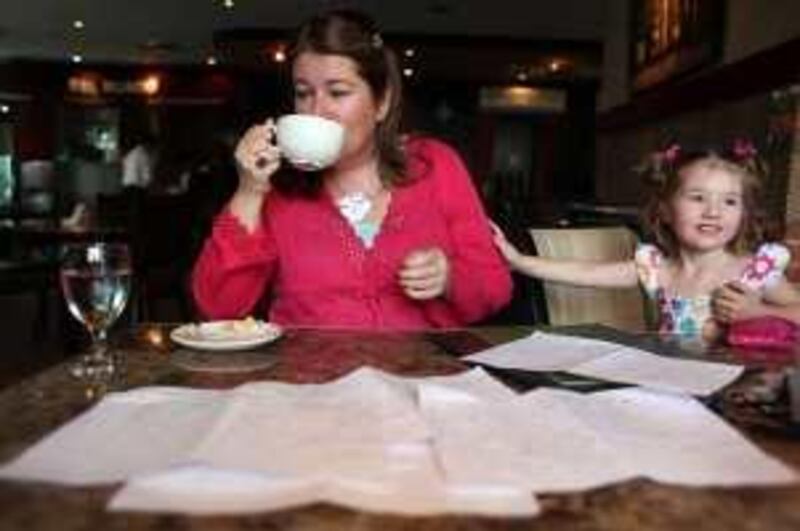 November 4, 2009 / Abu Dhabi / Imelda Popplewell with her daughter Katie, 3, at Cafe Bel Mondo. Imelda decided to track every Durham during the month of October using a hand writen log November 4, 2009. (Sammy Dallal / The National)

 *** Local Caption ***  sd-110409-money-04.jpg