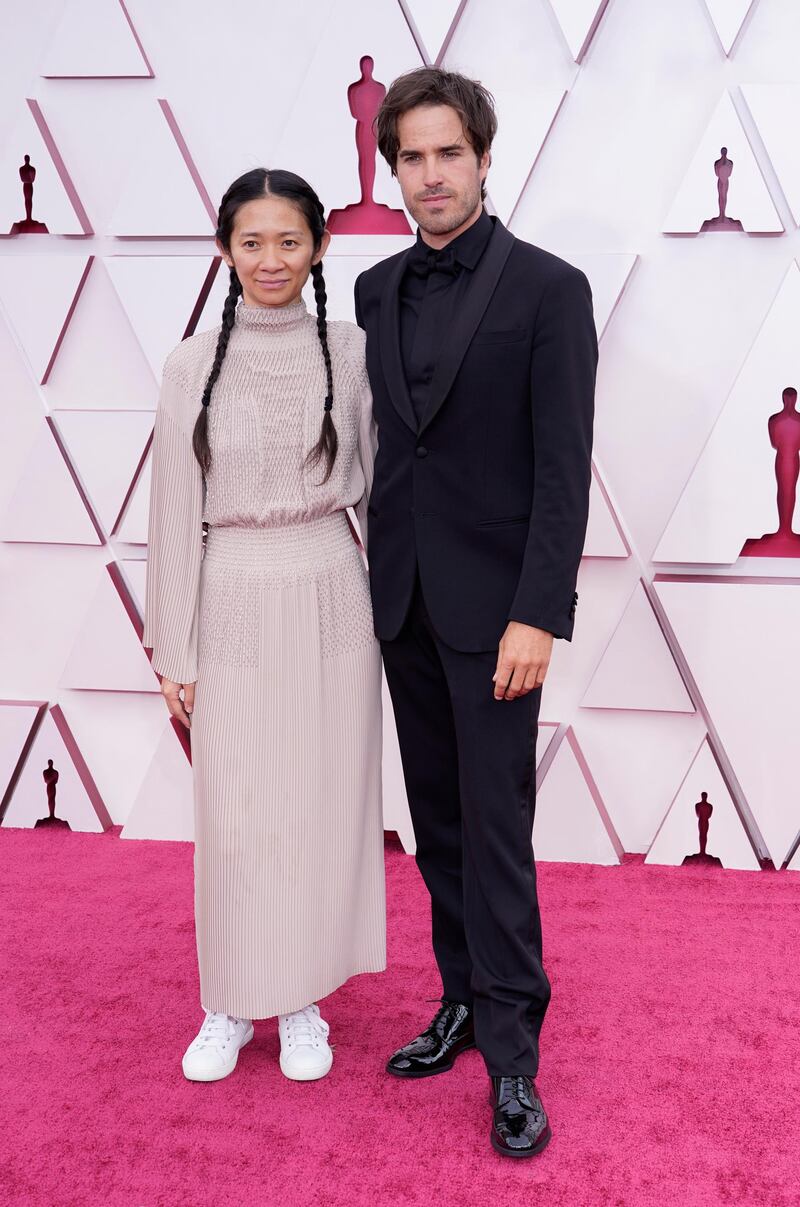 Chloe Zhao, in Hermes, and Joshua James Richards arrive for the 93rd annual Academy Awards ceremony at Union Station in Los Angeles, California, on, 25 April 25, 2021. EPA