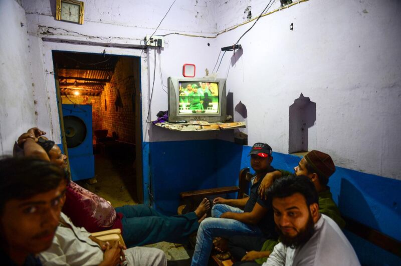Indian people watch a live broadcast of the match on a television at a tea shop in Allahabad. AFP