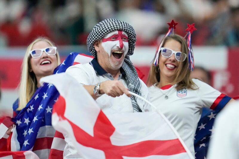 USA and England supporters find friendship in the football stands. AP