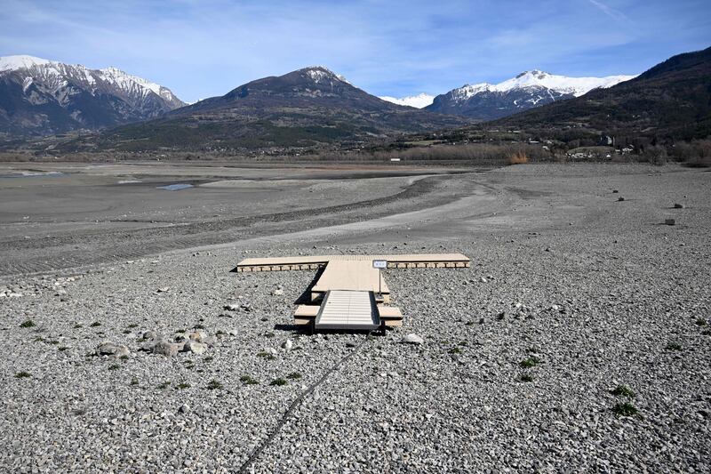 A photograph taken on March 16, 2023 shows the dried-up lake Serre-Poncon, near Embrun in the French Alps. AFP
