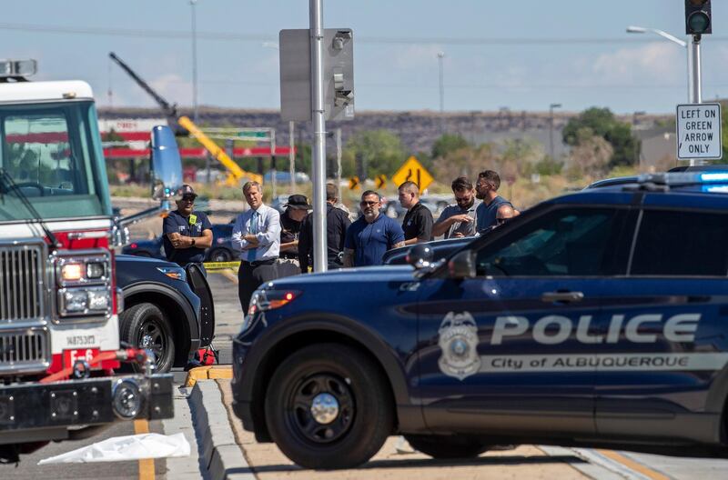 Albuquerque mayor Tim Keller, second from left, is briefed by officials at the site of a fatal balloon crash in Albuquerque, New Mexico. AP Photo