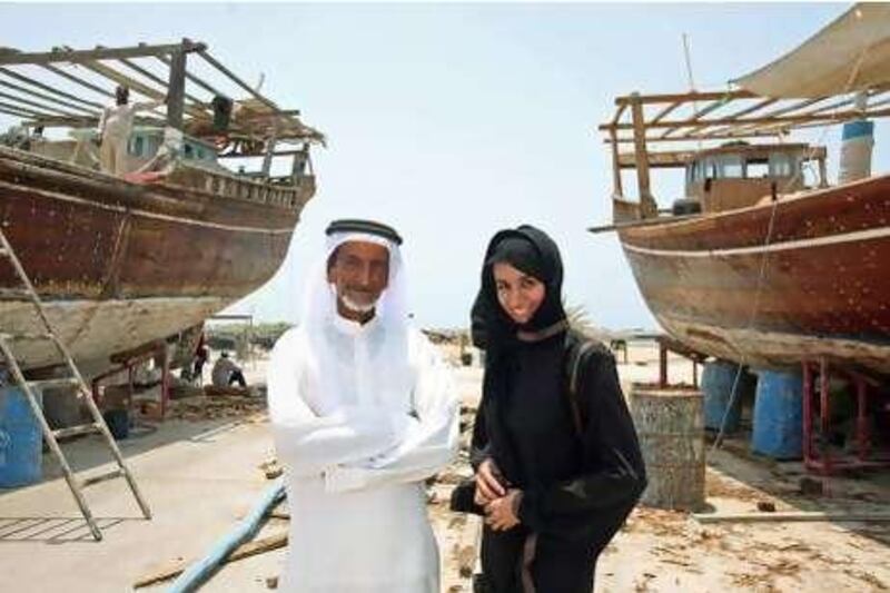 United Arab Emirates - Delma Island - July 27, 2010.

NATIONAL: Juma al Qubaisi (cq-al), and his daughter Ayesha al Qubaisi (cq-al), 30, pose for their portrait next to two of Juma's fishing boats on Delma Island on Tuesday, July 27, 2010. Amy Leang/The National