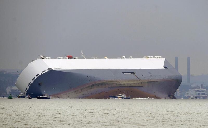 Tug boats move around the stricken cargo ship ‘Hoegh Osaka’ as it lies trapped on her side on the Brambles Sand Bank between Calshot Bay and The Isle of Wight, Britain. Gerry Penny / EPA