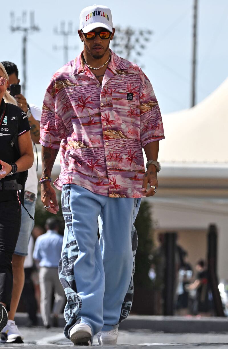 Lewis Hamilton, in a Tommy Jeans x Martine Rose shirt and jeans, arrives for the first practice session ahead of the Abu Dhabi Grand Prix on November 18, 2022. AFP