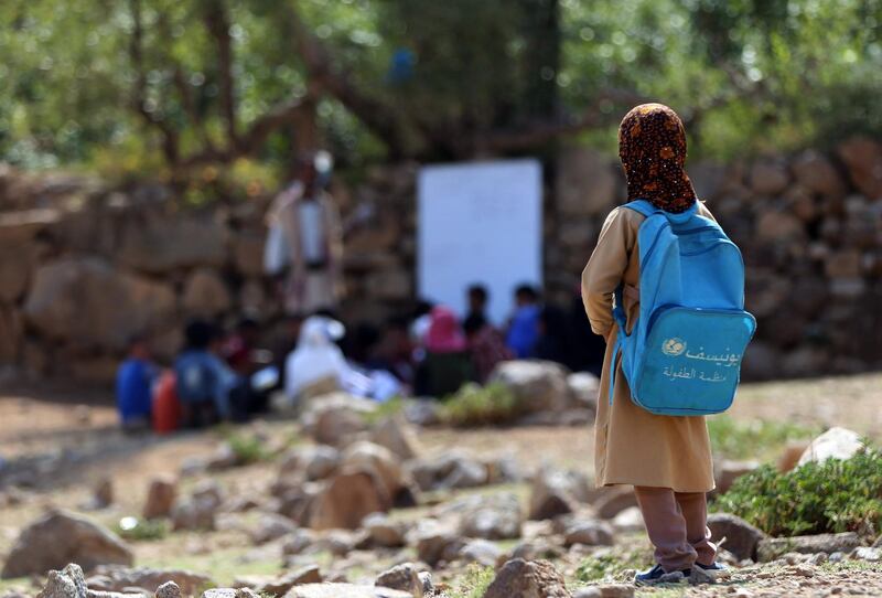 Yemeni school children attend an open-air class under a tree near their unfinished school on September 16, 2019 in the southwestern Yemeni village of al-Kashar in Taez governorate's Mashraa and Hadnan district at the start of the new academic year in the war battered country. The classes are given in a field outside the school which was under construction but was never completed when funding was stopped due to the war that broke out in Yemen in 2015. According to the UN, two million of the country's seven million children of school age go without education in Yemen. More than 2,500 schools are out of use across Yemen, of which two thirds have been damaged in attacks, 27 percent closed and seven percent used by the military or as shelters for displaced people.
 / AFP / Ahmad AL-BASHA
