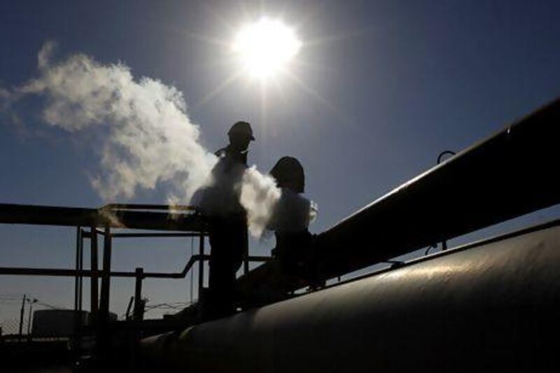 An oil worker at a refinery in Brega, eastern Libya. Outages in Libya and the Syrian crisis have driven up the price of US crude. Hussein Malla / AP Photo