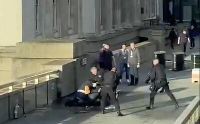 In this grab taken from video made available by @HLOBlog, a man is surrounded by armed police after an incident on London Bridge, in London, Friday, Nov. 29, 2019. A man wearing a fake explosive vest stabbed several people before being tackled by members of the public and then shot dead by armed officers on London Bridge, police and the cityâ€™s mayor say. Police say they are treating it as a terrorist attack. (@HLOBlog via AP)
