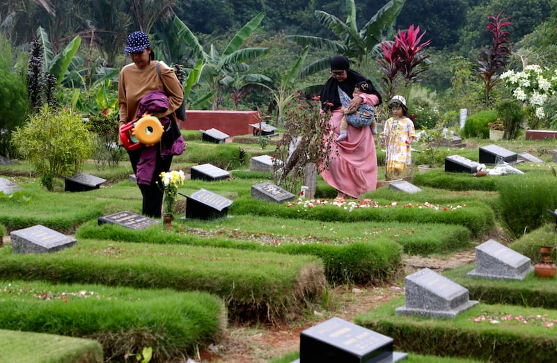 Visiting graves at a Covid-19 cemetery in Depok, Indonesia. The practice is one of the traditions carried out by Muslims before Ramadan in the South-east Asian country. EPA