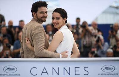 TOPSHOT - Egyptian director A.B Shawky (L) and producer Dina Emam pose on May 10, 2018 during a photocall for the film "Yomeddine" at the 71st edition of the Cannes Film Festival in Cannes, southern France.  / AFP / Anne-Christine POUJOULAT
