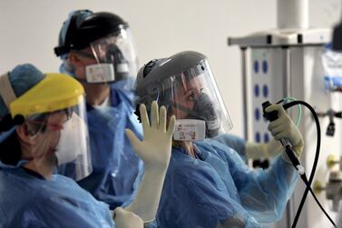 Medical staff care for a patient with coronavirus in the intensive care unit at Royal Papworth Hospital in Cambridge, England. More than 100,000 people have died in the UK after contracting the virus, according to government figures released January 26, 2021. Britain is the fifth country in the world to pass that mark, after the United States, Brazil, India and Mexico, and by far the smallest. Neil Hall/Pool via AP File